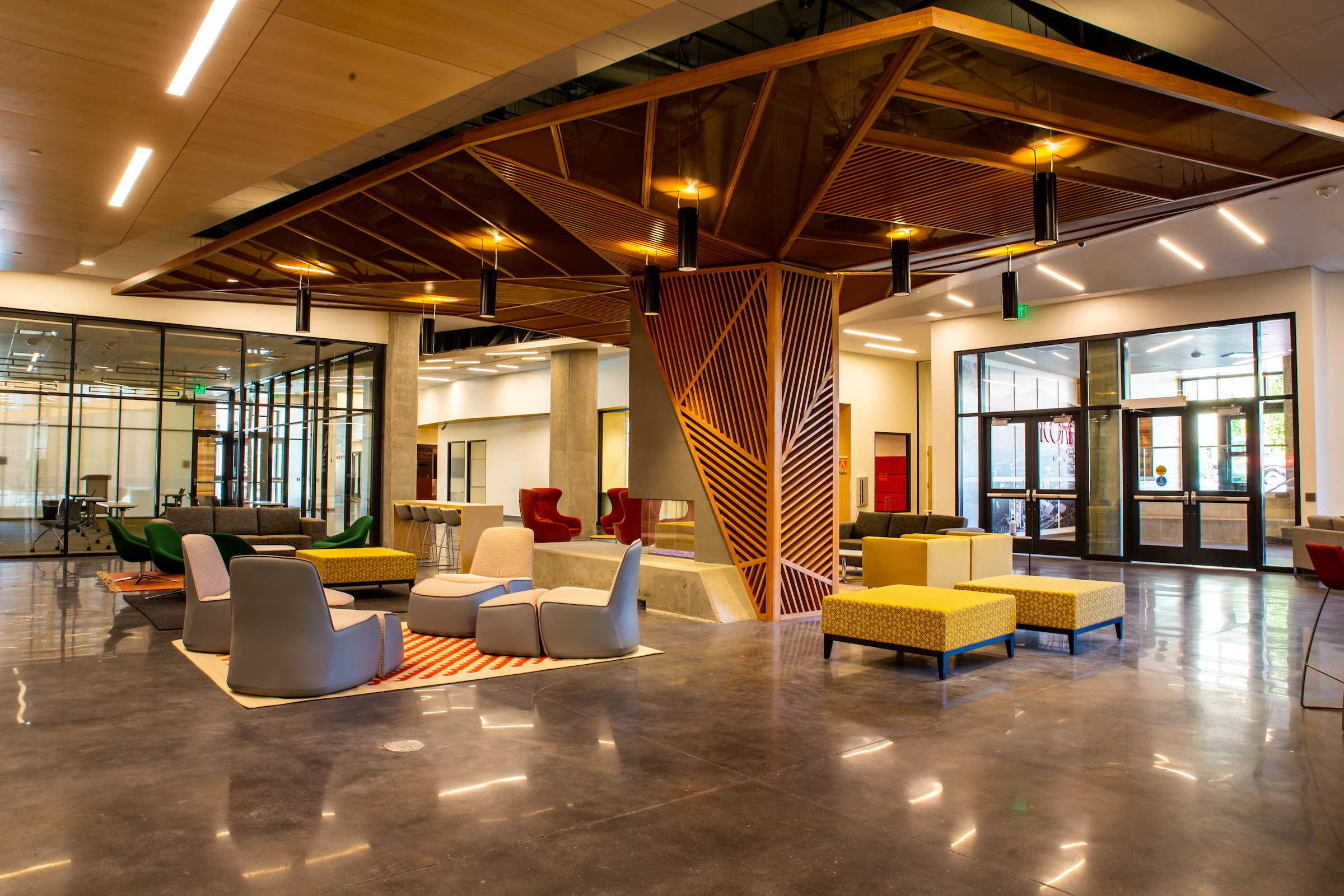 an enterior common space with comfortable chairs in the Kahlert Village residence hall