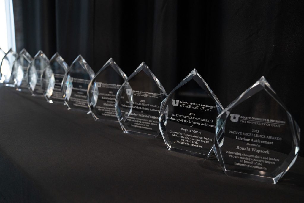 A row of crystal awards on a black table