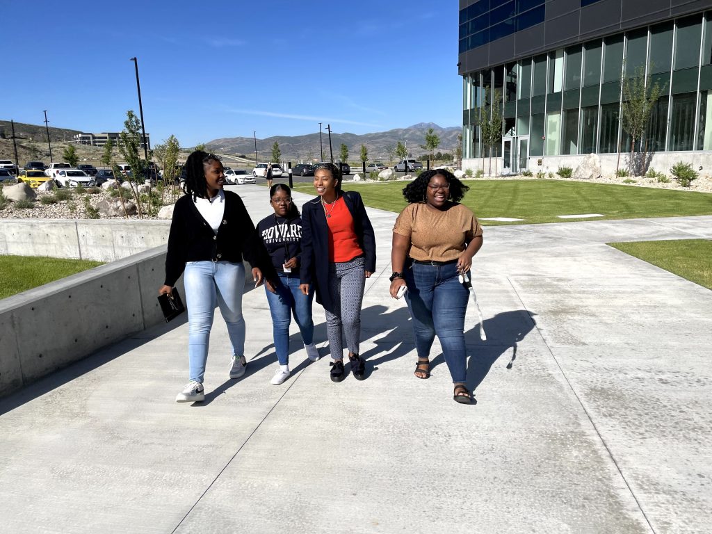 a group of IMPACT scholars walking with Simone Lawrence on the University of Utah campus