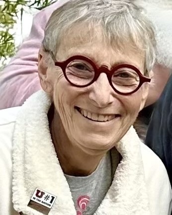 Anne Asman wearing round frame glasses and a fluffy, wool jacket