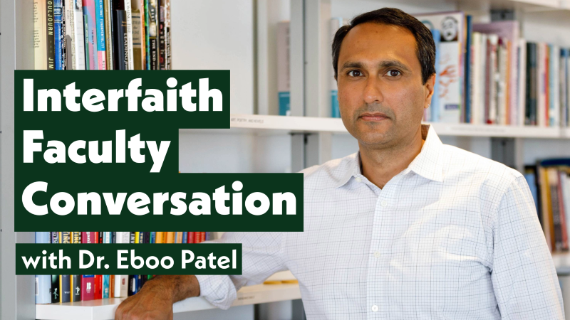 Eboo Patel stands in a library aisle