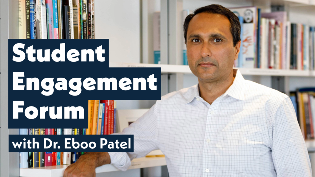 Eboo Patel stands in a library aisle