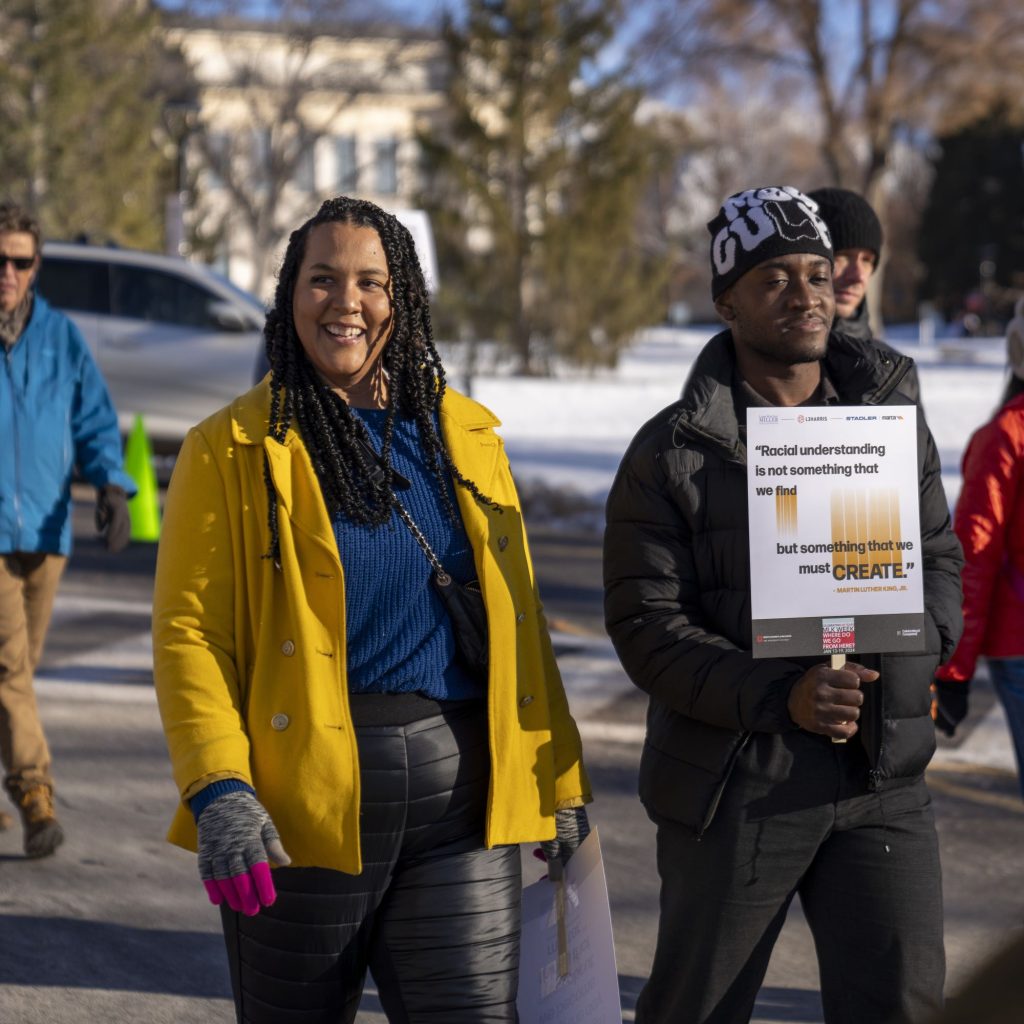 Sara Cody and Ephraim Kum march at the 2024 MLK Day Rally and March.